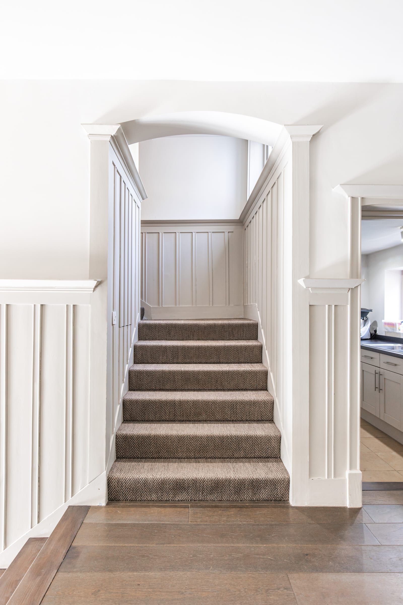 Original timber panelling and arched doorway in the reception hall