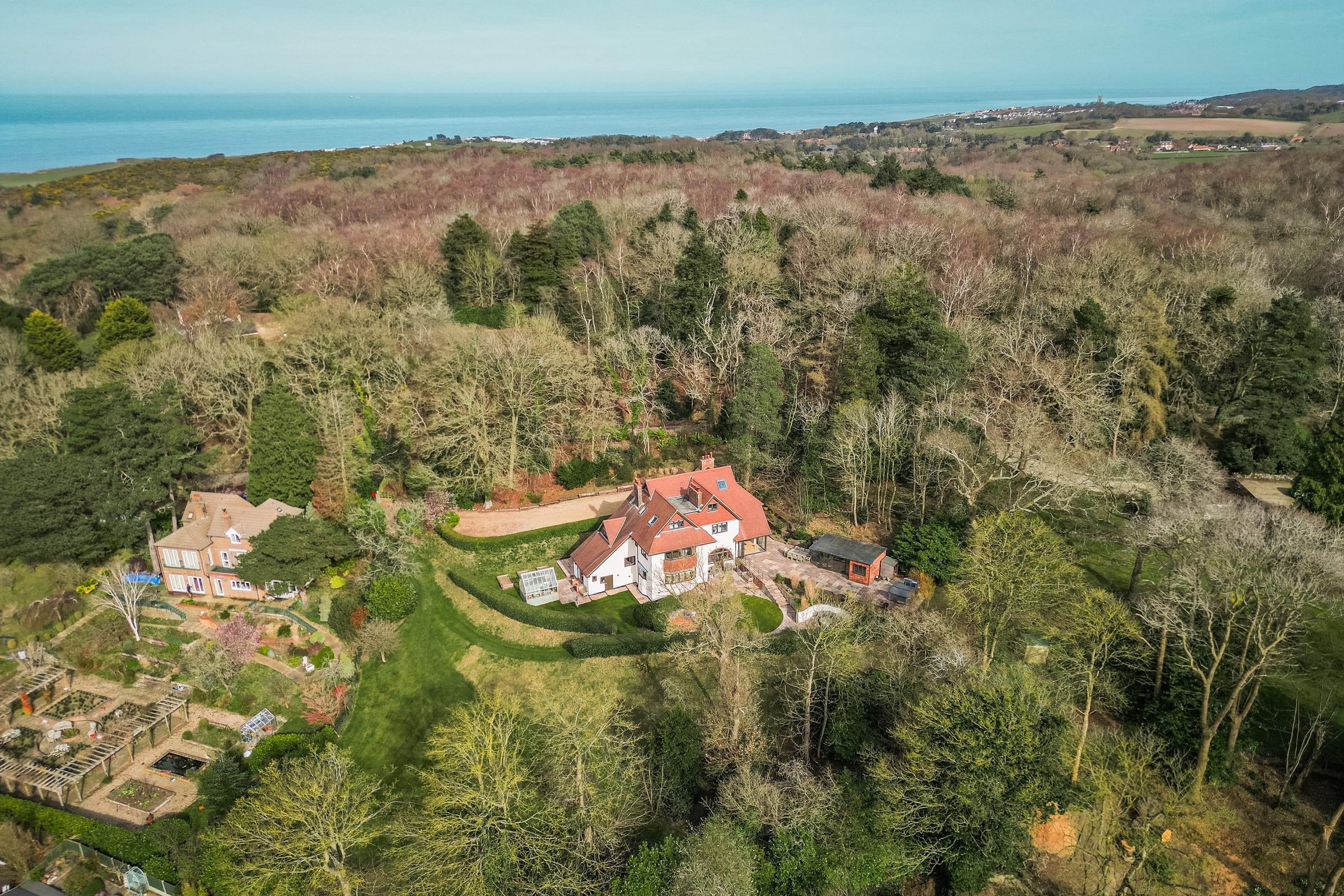 Aerial view of Orchid Lee, a character family home set in extensive grounds near the coast